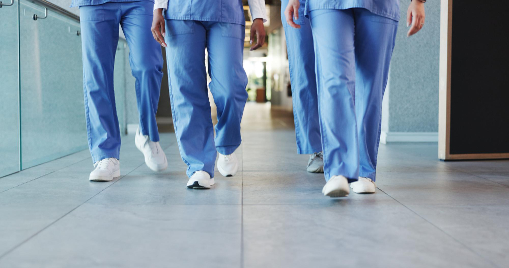 Theatre staff walking down a hospital corridor