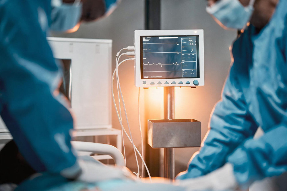 Anaesthetic team monitoring a patient on theatre monitors
