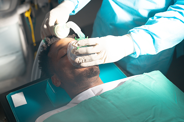 An anaesthetist placing an anaesthetic mask over a patient before surgery